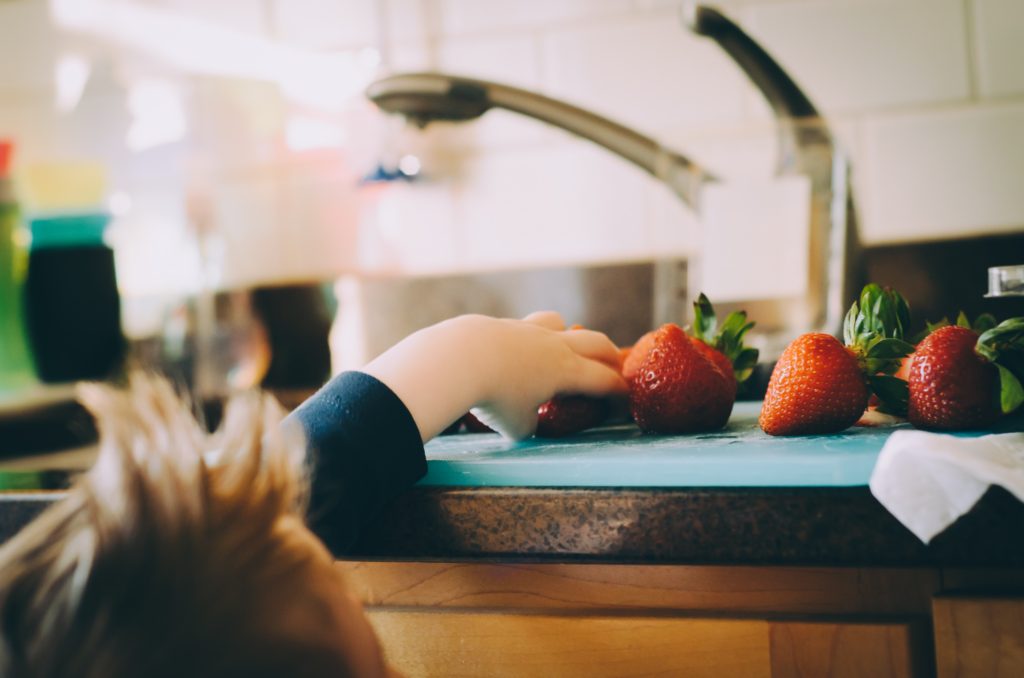 photo of child helping in the kitchen | healthy eating tips for kids