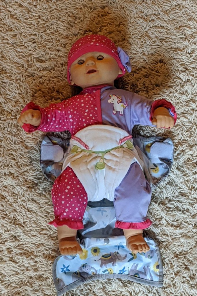 photo of doll wearing a cloth diaper