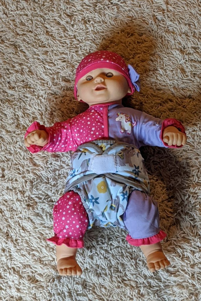 photo of doll wearing a cloth diaper