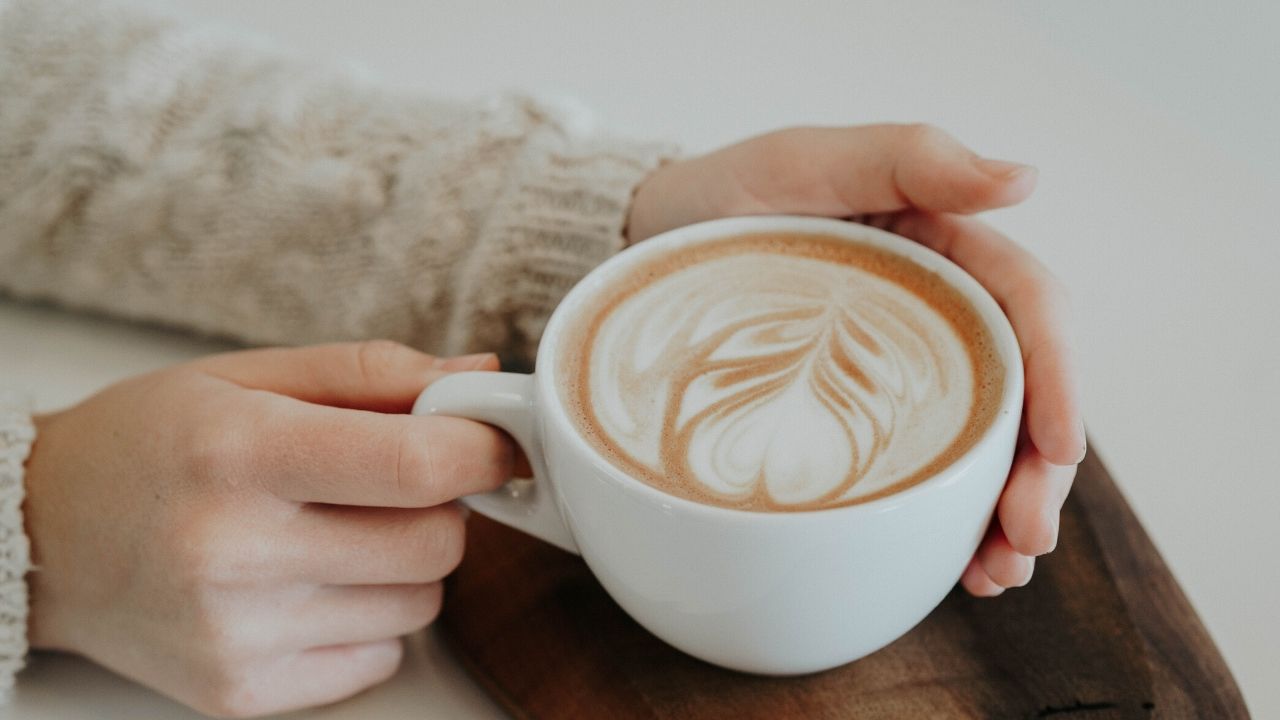 photo of someone holding a cup of coffee