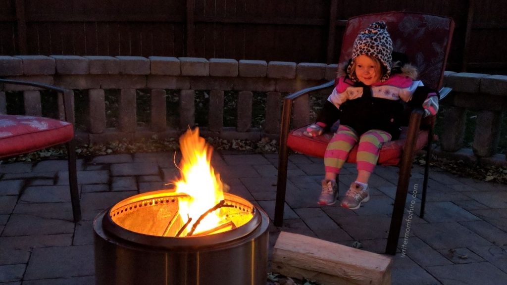 toddler sitting by the solo stove bonfire pit