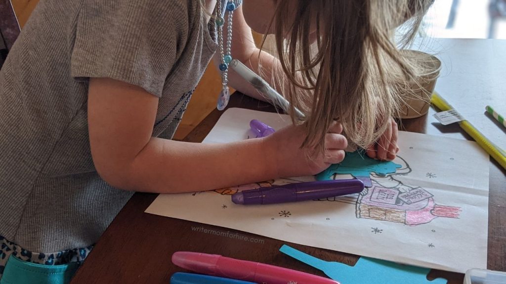 older child crafting with art and craft supplies