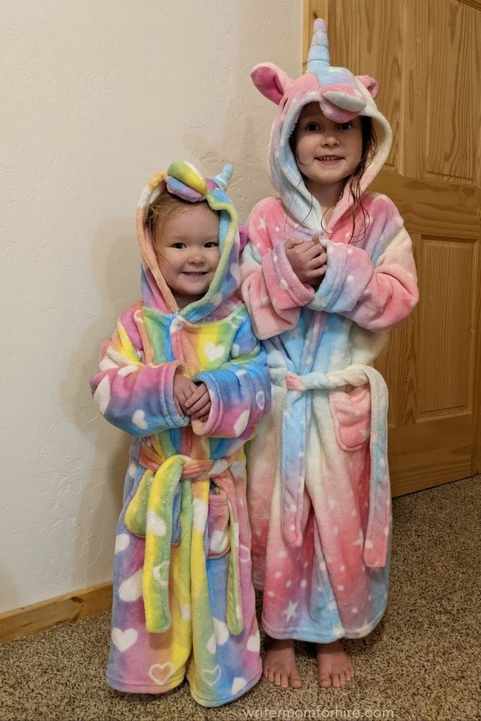 girls wearing unicorn robes